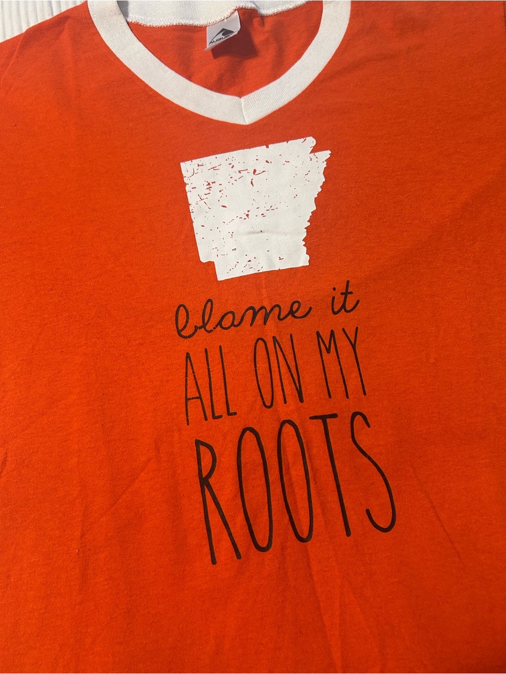 Ruby’s Rubbish Orange Tee with White V-Neck and Arkansas State Graphic